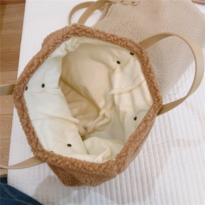 Detailed view of brown teddy fleece tote bag interior with PU leather straps and ties