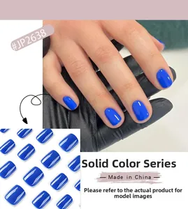 Detailed view of glossy cobalt blue short press-on nails set in solid color finish