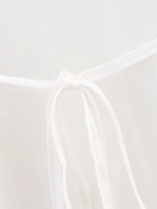 Detail of white cotton-linen kimono set featuring a delicate tie-knot waistband closure