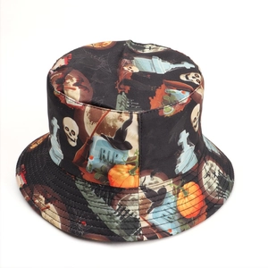 Detailed view of Halloween bucket hat featuring skull, pumpkin, and RIP gravestone prints