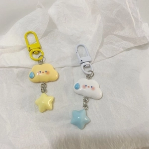 Close-up of cute resin cloud and star keychains in yellow and white with D-rings