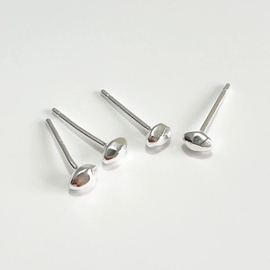 Macro shot of minimalist silver stud earrings with S925 hallmark on white background