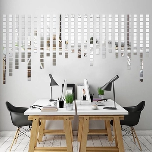 Macro shot of silver square acrylic mirror stickers arranged in a modern grid wall layout