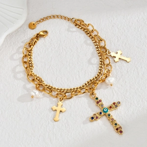 Detailed view of 18K gold double-layer necklace with cross pendants and white pearls