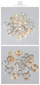 Macro detail of geometric CCB heart, flower and square charms for DIY jewelry making