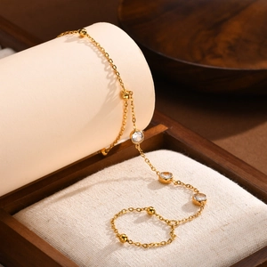Close-up of 18K gold-plated double-layer bracelet featuring clear zircon and golden beads