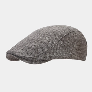 Close-up of the grey knitted texture and side profile of the vintage beret flat cap