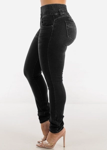 Detail of high waist elastic denim jeans showing side slim fit cut in black color