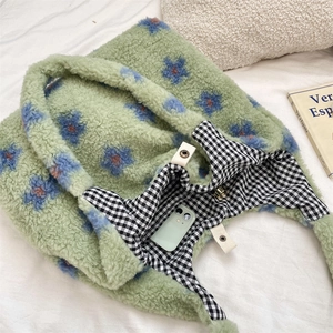 Detail of plush tote bag showing gingham lining and interior pocket with a smartphone