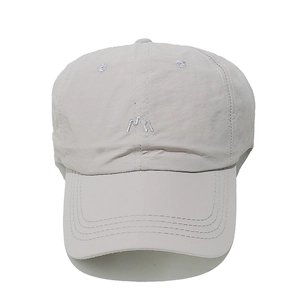 Detailed embroidery of white abstract M logo on breathable beige nylon baseball cap