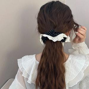 Vintage black polka dot lace scrunchie shown in a professional lifestyle hair styling shot