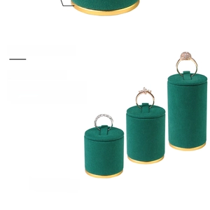 Three-piece dark green velvet ring display stands with gold bases in tiered heights