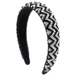 Handmade beaded headband with black and white zigzag patterns on a wide padded base