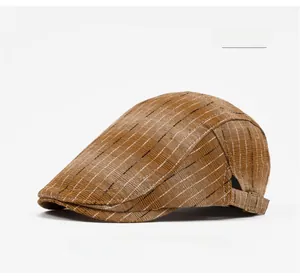 Close-up of khaki striped flat cap featuring woven texture and metal side buckle
