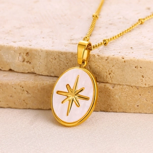 Detailed macro view of the gold oval pendant with mother of pearl and star star design