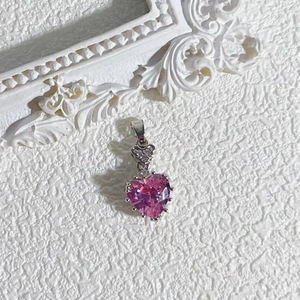 Close-up of heart-shaped pink zircon pendant with silver 18K plated details