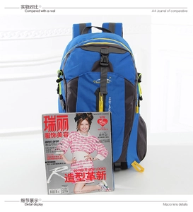 Blue and gray outdoor travel backpack shown with magazine for size comparison and scale