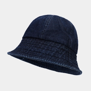Close-up of deep blue denim bucket hat with detailed multi-row stitching on the brim