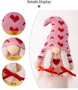 Close-up of pink knitted Valentine gnome showing heart patterns and soft nose detail