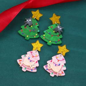 Christmas kitten earrings with acrylic trees and gold stars on green velvet background