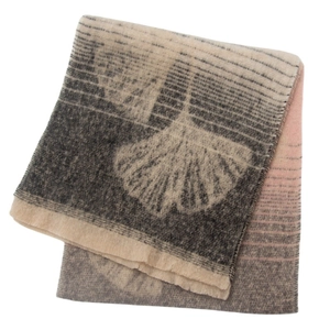 Detailed view of thick bouclé yarn scarf featuring woven ginkgo leaves and fringe