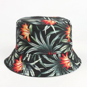 Detail view of double-sided bucket hat with vibrant tropical floral and palm leaf print