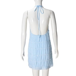 Detail view showing layered ruffles and pleated chiffon fabric on a light blue dress
