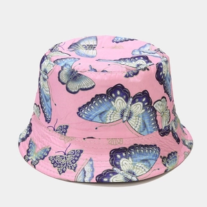 Detail of pink reversible bucket hat with blue and white butterfly pattern and stitching