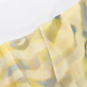 Detailed macro view of the floral print mesh fabric with high-quality overlock stitching