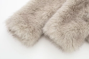 Close-up of the soft light gray faux fur texture and long plush material details