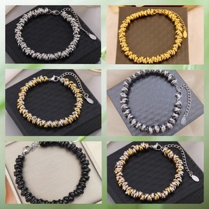 Detail showing six styles of stainless steel twisted bracelets in multiple metallic colors