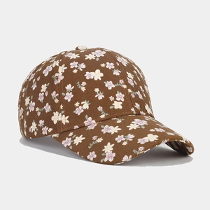 Close-up of coffee brown baseball cap featuring delicate floral pattern and twill texture