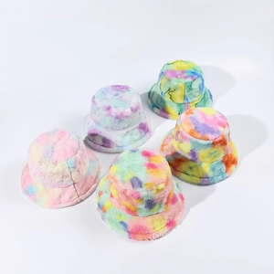 Detail showing various candy-colored tie-dye plush bucket hats in soft faux fur material