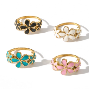 Set of four stainless steel rings with colorful enamel flowers in white, black, pink and teal