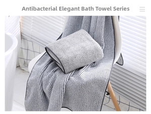 Detail of dark grey striped bamboo charcoal fiber bath towel with black hemmed edges