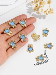 Detail shot of golden bow pendant with blue gem including dimensions 1.3cm by 1.8cm