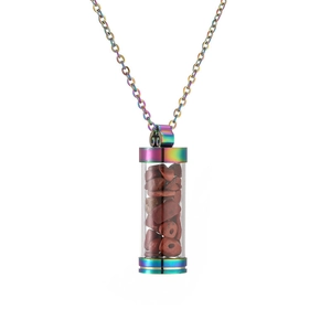 Detailed macro view of an openable rainbow glass vial pendant filled with red gemstones