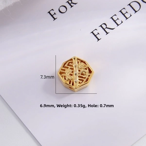 Macro shot of gold-plated bamboo motif spacer bead showing detailed 7.3mm dimensions