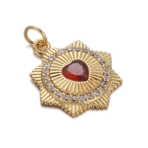 Golden sunburst pendant necklace with red heart-shaped gemstone and crystal accents