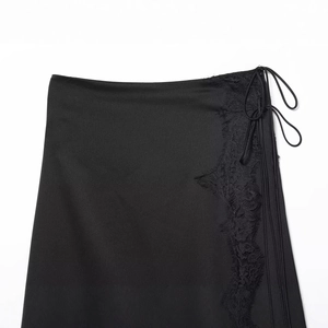 Chic black satin midi skirt with elegant lace trim and side tie detail on white background