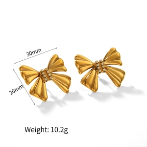 Gold bow earrings with crystal inlay and 30x26mm dimension details on white background