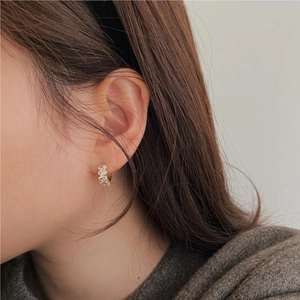 Elegant gold plated sterling silver hoop earrings with clear zircon stones on female model
