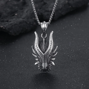 Macro detail of a vintage silver dragon head pendant on a punk titanium steel necklace