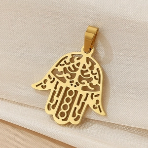 Macro shot of 18K gold plated Hamsa Hand charm with intricate hollow-out metal design