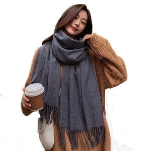 Elegant grey wool blend scarf for women featuring fringe details on a white background