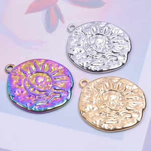 Detailed view of colorful rainbow and gold sun relief pendants with circular sunburst texture