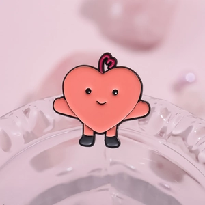 Pink heart enamel pin with cute cartoon arms and legs displayed on a glass edge