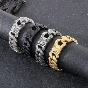 Detail of vintage dragon-head clasp cuban chains in silver, black, gold and antique silver