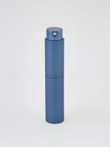 Close-up of matte blue portable perfume atomiser bottle with a rotating spray nozzle