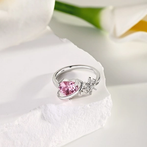 Macro shot of S925 silver ring featuring pink heart zircon and floral diamond accents